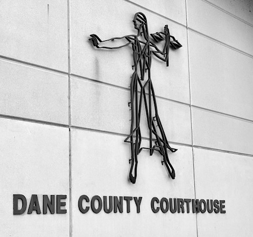 Metal art of Lady Justice on outside of Dane County Courthouse